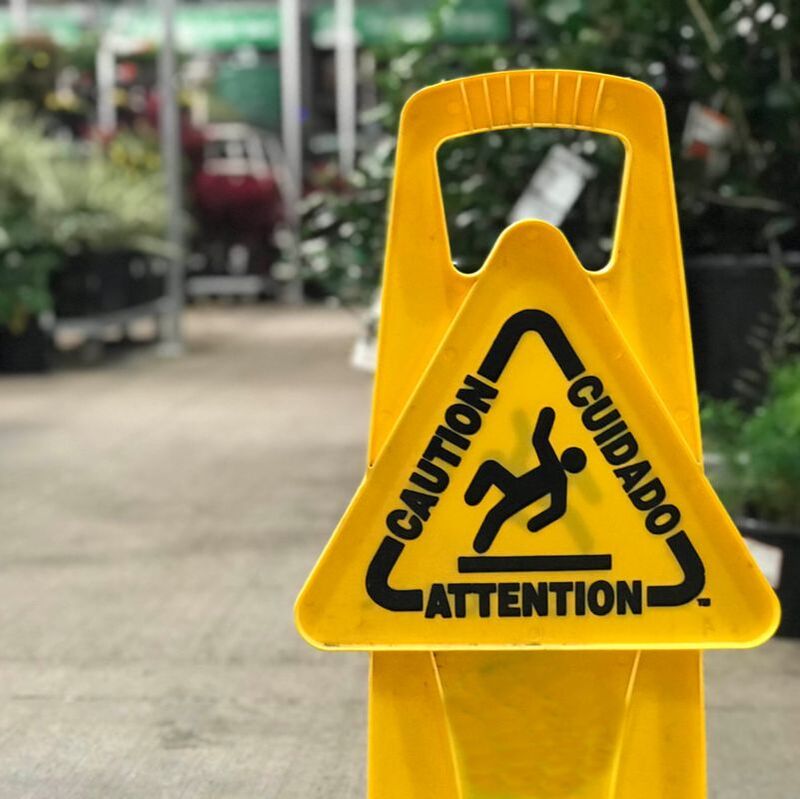 Picture of yellow caution sign in a retail space