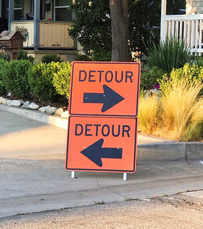 Picture of orange 2 way detour sign in front of driveway